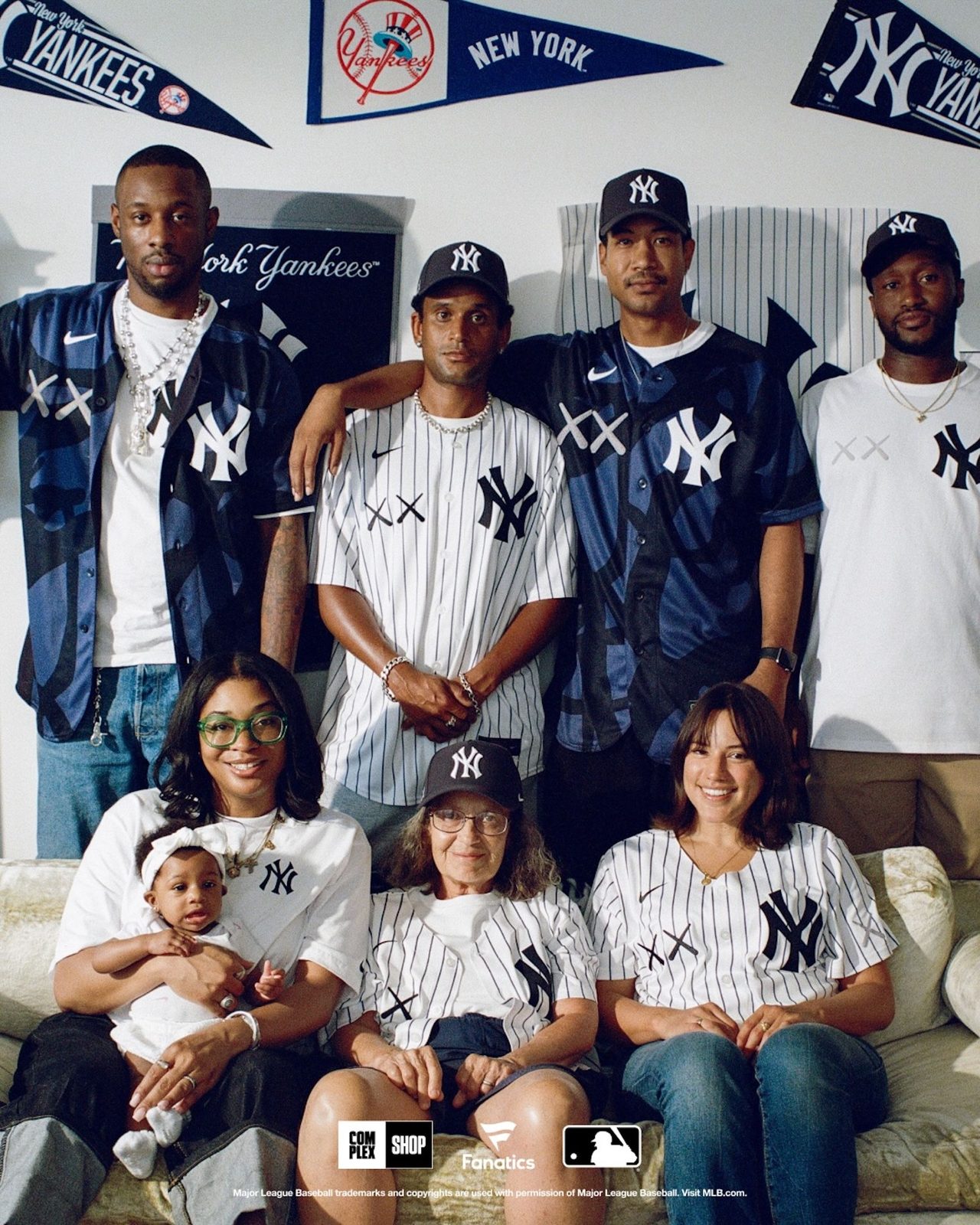 Family wearing KAWS x MLB Yankees collab items in a lifestyle photo