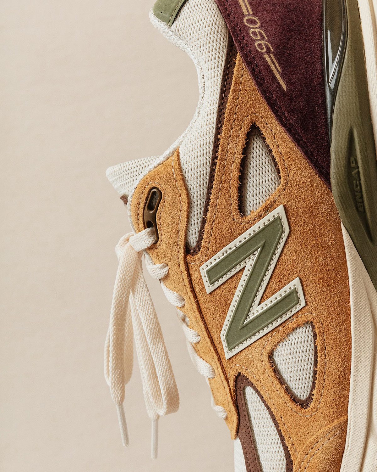 Close-up of the 990v4 Patina side N logo and suede
